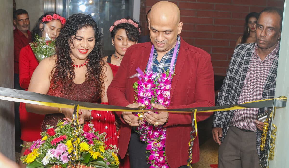 An image of two people cutting the ribbon